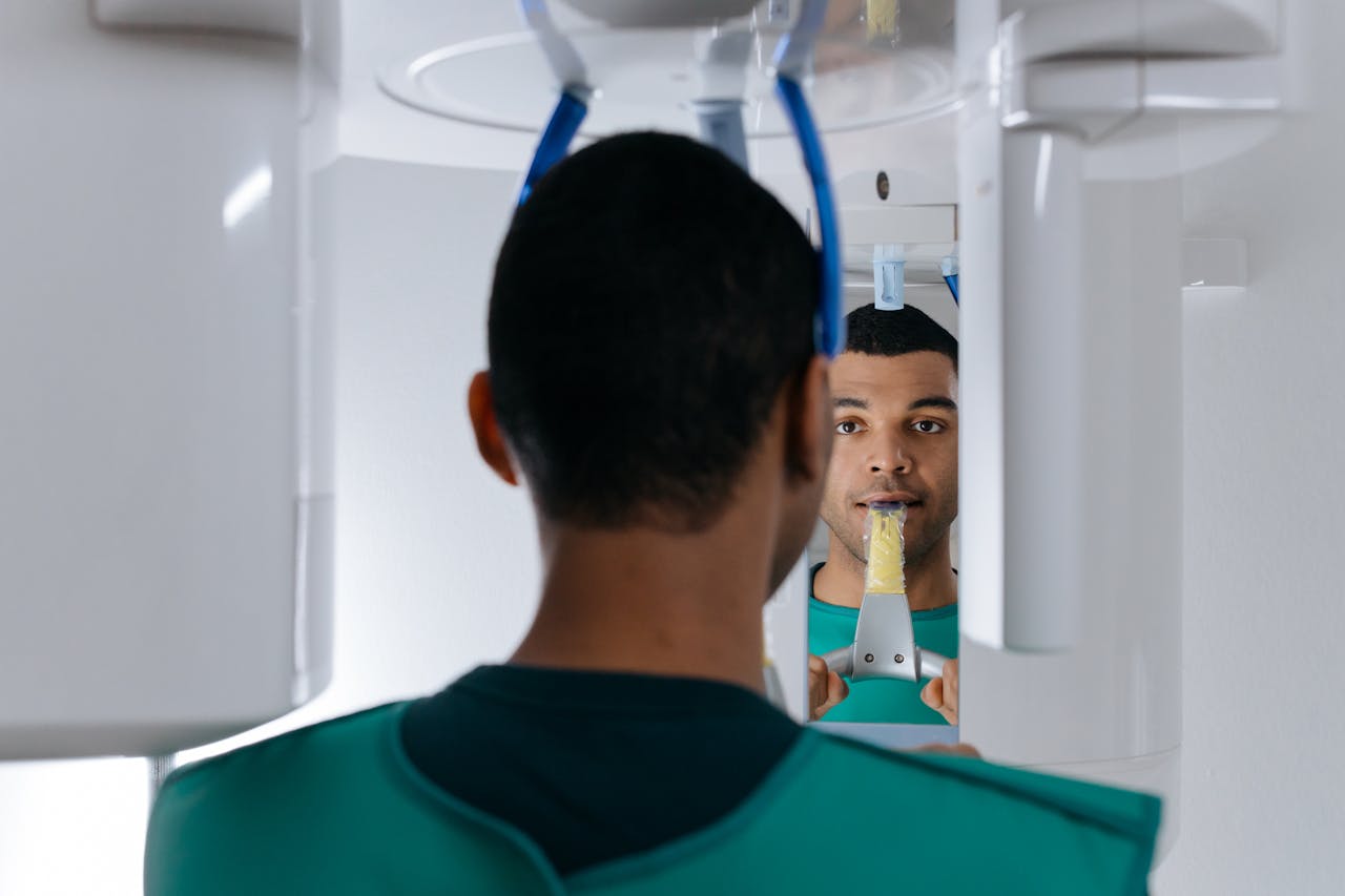 services-img Man undergoing dental panoramic X-ray for oral health examination in a clinic.